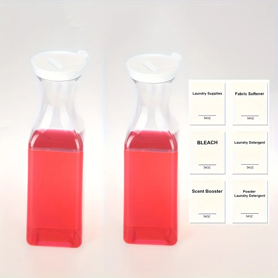 Two clear glass liquid laundry detergent dispensers filled with red liquid and labeled laundry supplies.