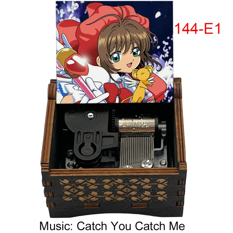 A wooden box containing a musical tone box and an anime figure, labeled 144-E1.