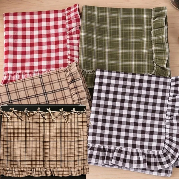 A collection of plaid fabric covers, including red and white, olive green, and brown tones.