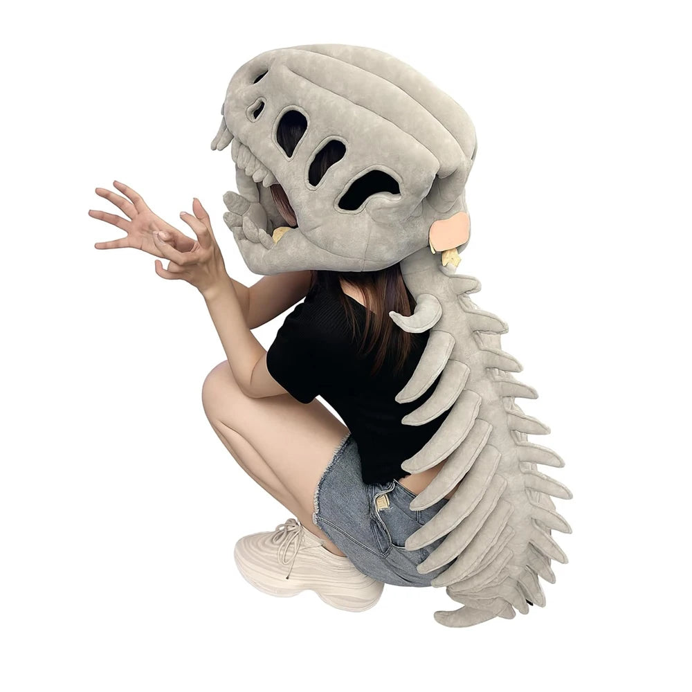 A person wearing a dinosaur skeleton costume with a large skull mask and a long, segmented spine.