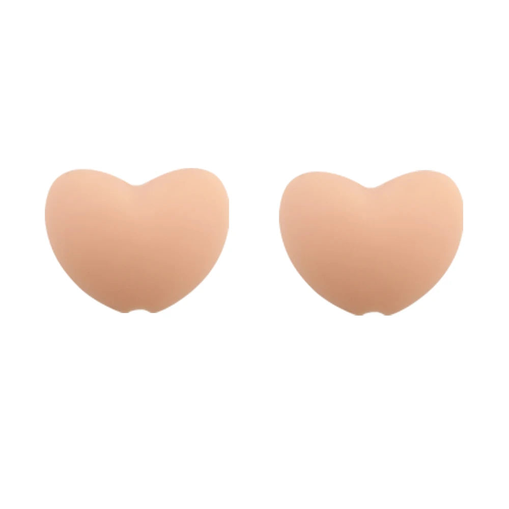 A pair of light peach silicone heart-shaped charm beads for DIY jewelry.