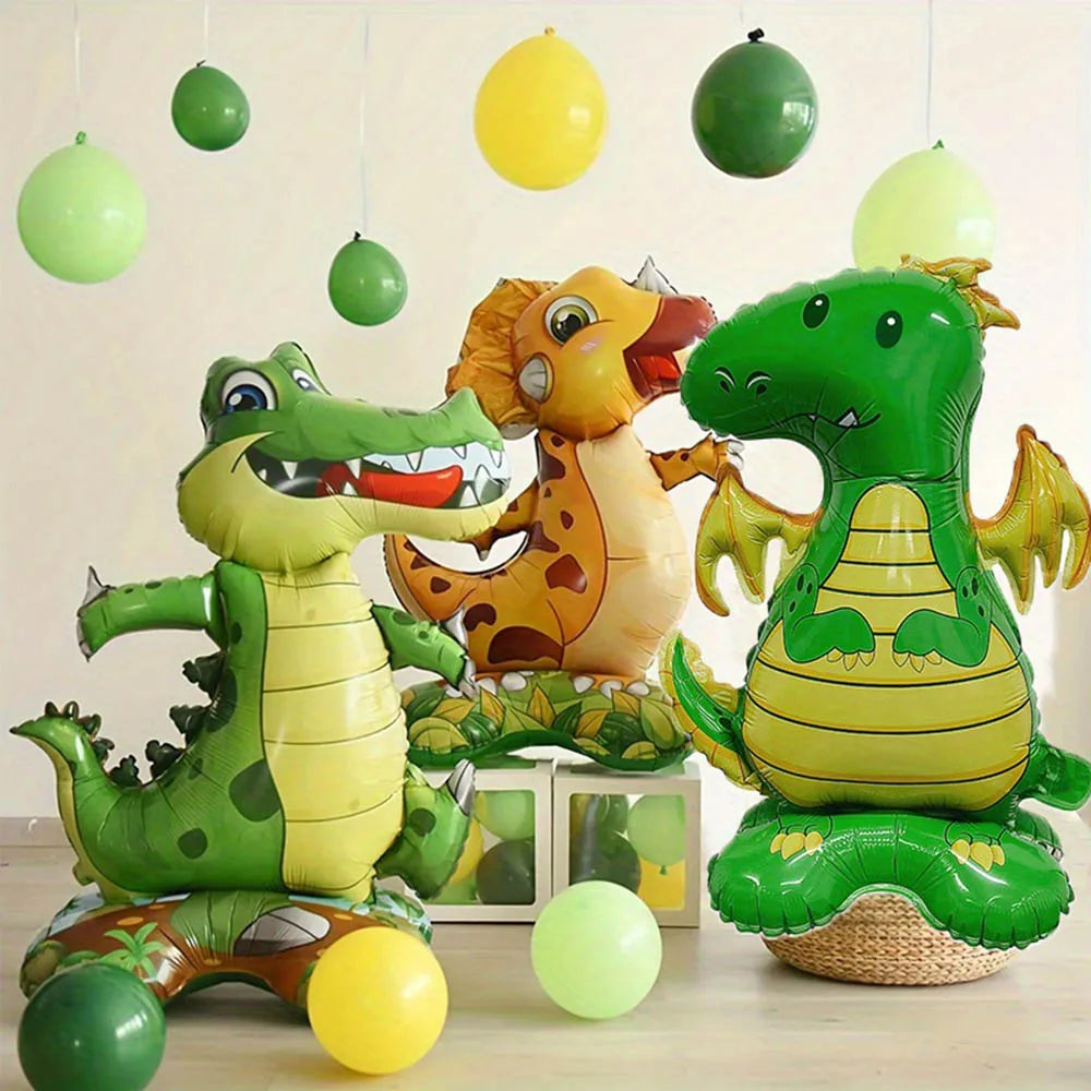 A collection of green and yellow cartoon animal foil balloons, including a dinosaur and a dog, hanging in the air.