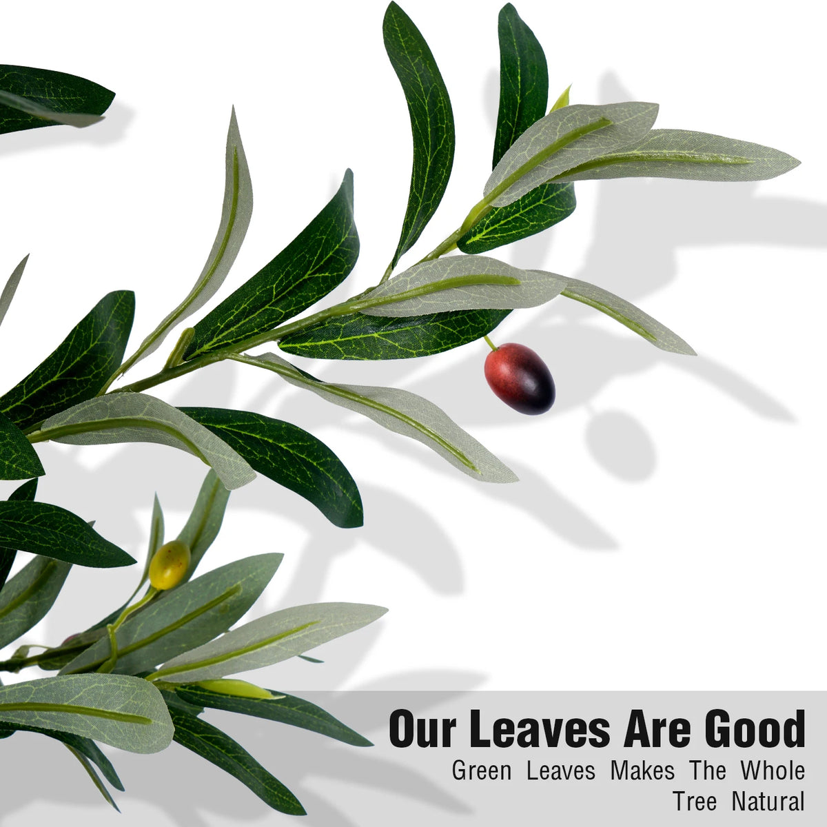 A branch of an artificial olive tree showing green leaves and a single red olive fruit.