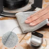 A hand is holding a mesh steel wire cleaning cloth, demonstrating its texture and use for cleaning.