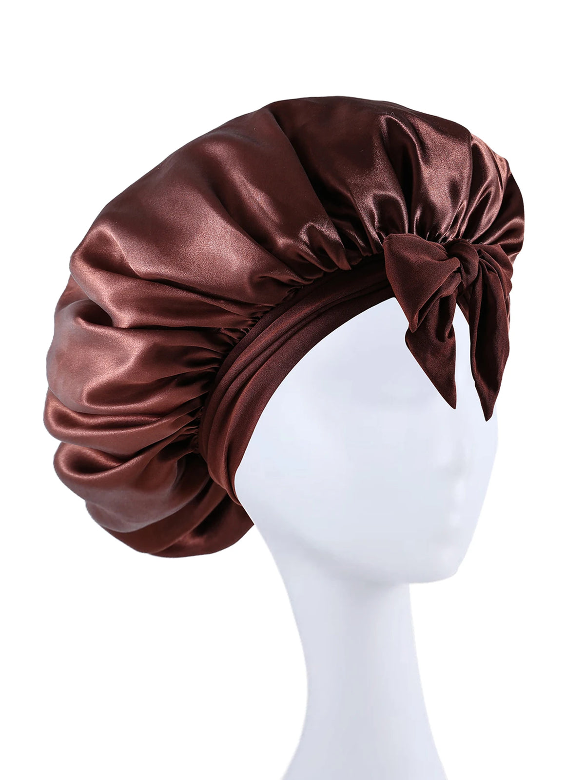 A dark brown silky satin sleep bonnet tied in a bow displayed on a white mannequin head.