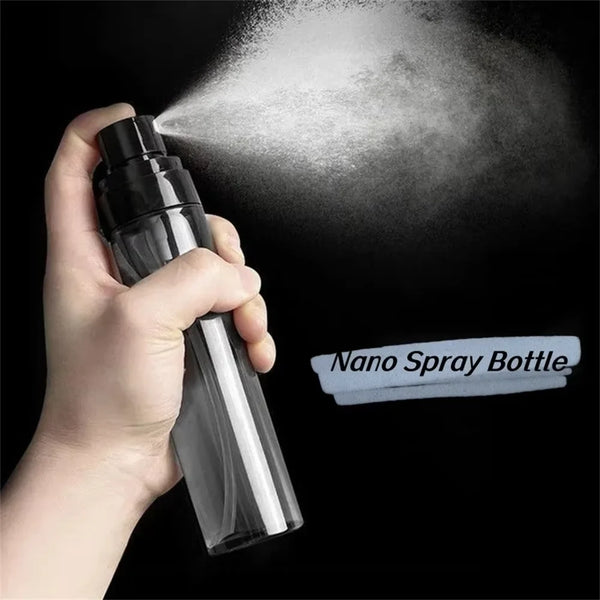 A hand is spraying a fine mist from a clear bottle labeled Nano Spray Bottle against a black background.