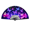 A holographic gradient rave hand fan featuring iridescent butterflies and stars against a vibrant purple background.