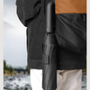 A black windproof automatic folding umbrella is shown hanging on a person's jacket.