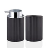 Black corrugated foaming soap dispenser with a silver pump and toothbrush holder.