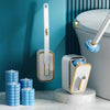 A white replaceable disposable toilet cleaning brush is shown next to a modern toilet and stacked blue cleaning discs.