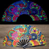 A holographic gradient rave hand fan with vibrant, colorful, swirling patterns.