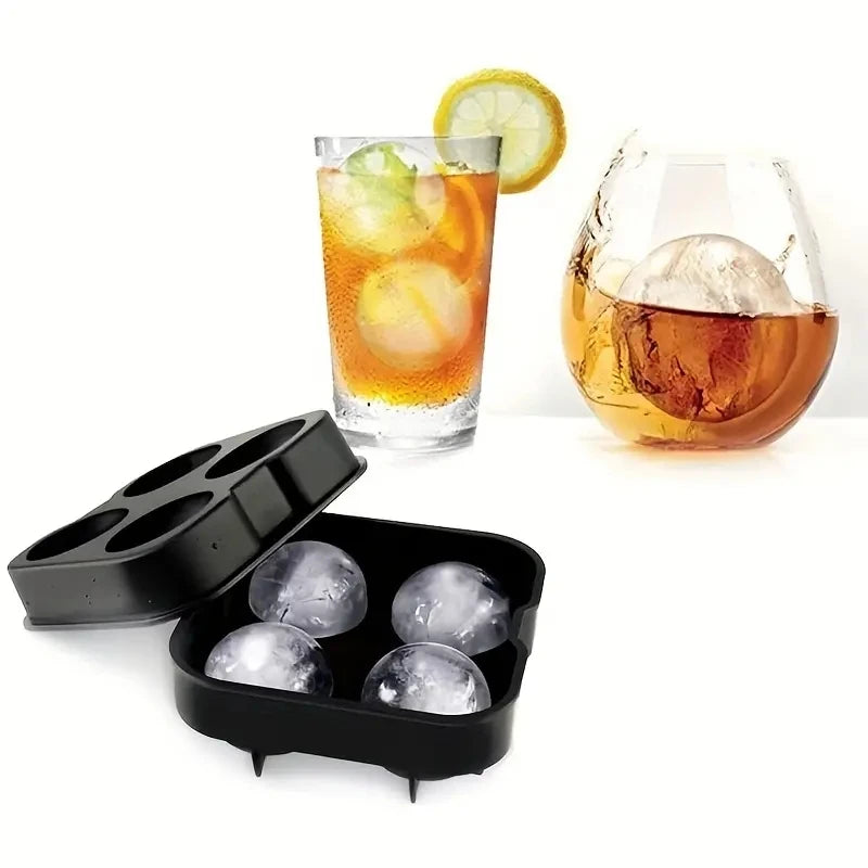 A silicone ice cube mold with a lid is shown next to a glass of iced tea and a slice of lemon.