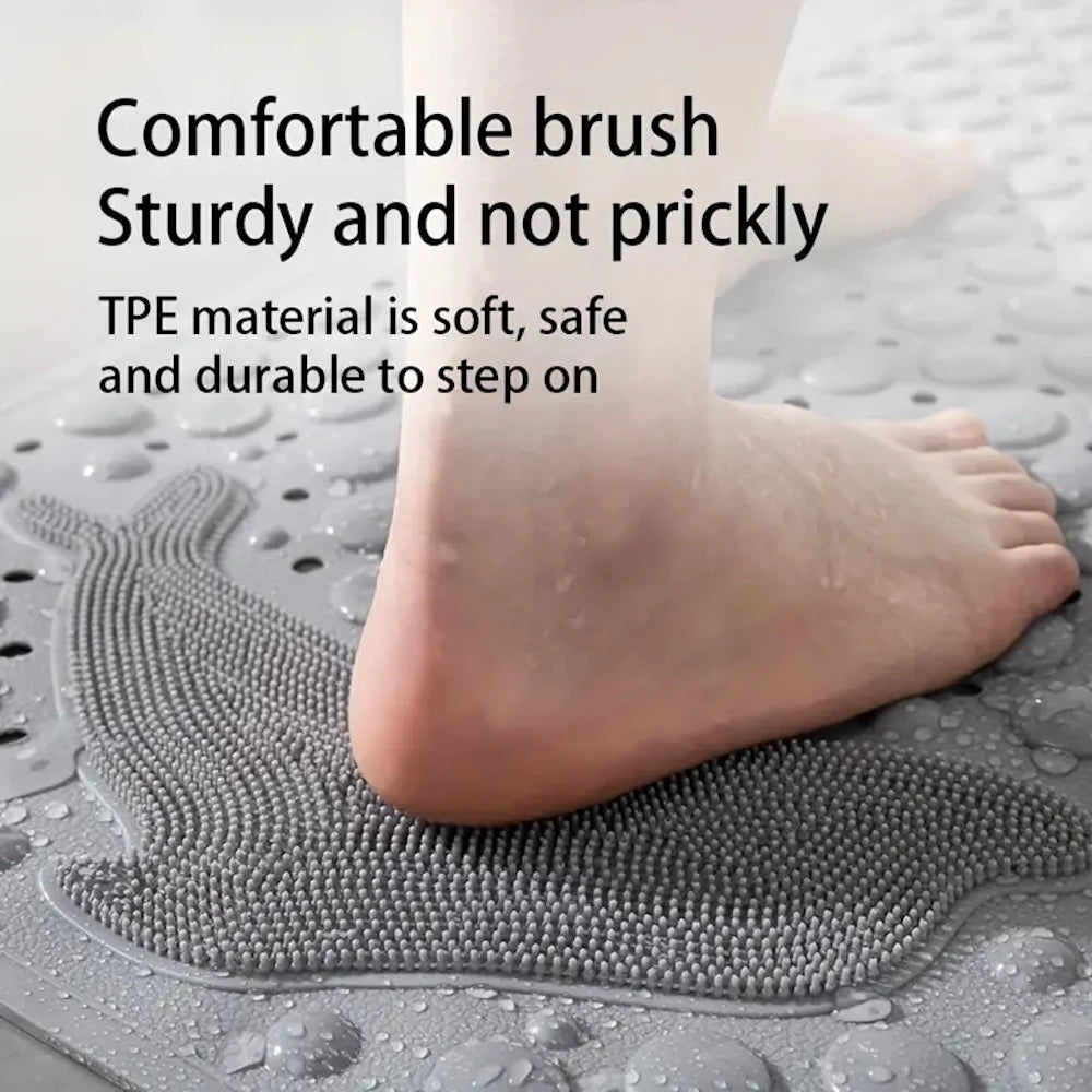 A foot is stepping on a gray silicone mat with textured bumps, demonstrating a comfortable brush sturdy and not prickly surfa