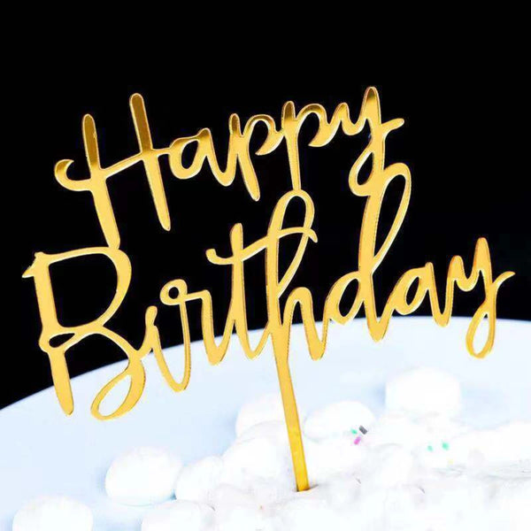 Gold acrylic birthday toppers set on a white surface