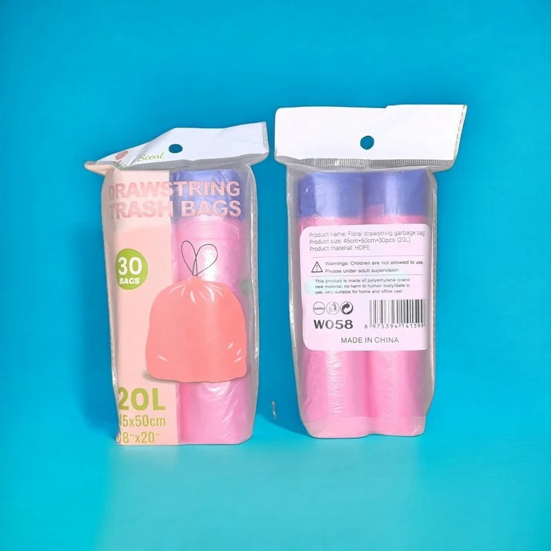 A package of pink drawstring trash bags with a white plastic bag and a label showing 30 bags.