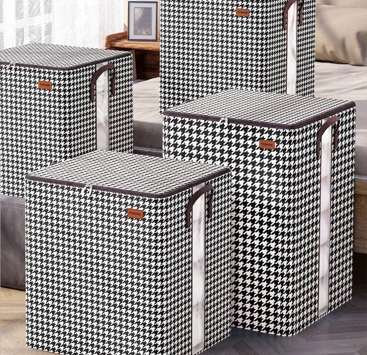 A set of black and white checkered non-woven quilt storage boxes with clear windows on a wooden surface.