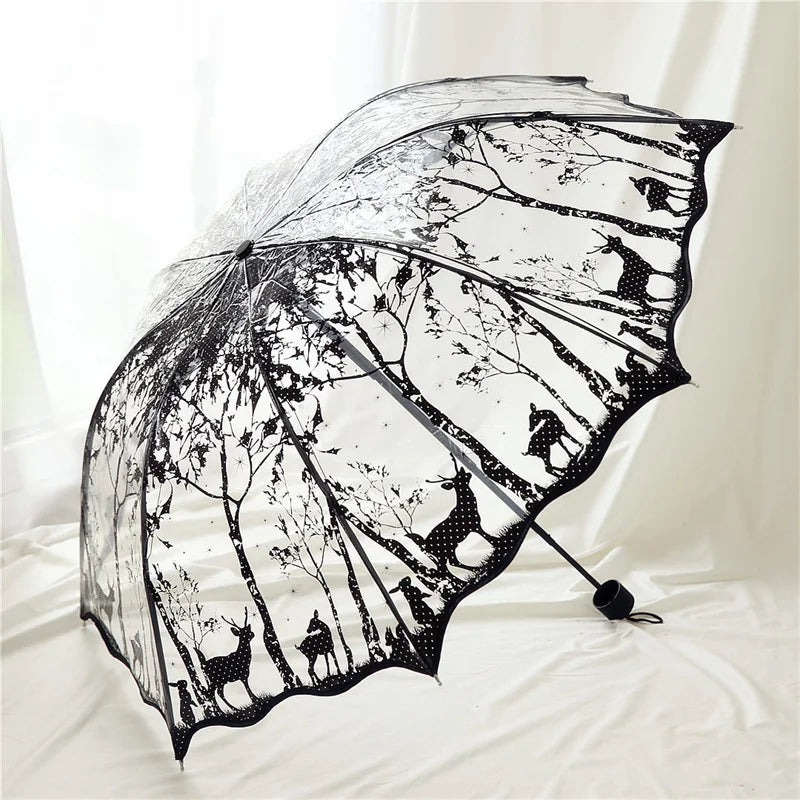 A black retro transparent folding umbrella with a silhouette pattern of deer and other animals.