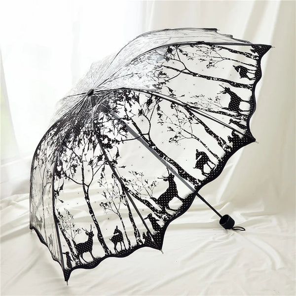 A black retro transparent folding umbrella with a silhouette pattern of deer and other animals.