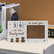 A white wooden pregnancy countdown picture frame with the number 39 and text to meet you