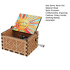 A small wooden music box with an engraved sun design and a rotary handle.