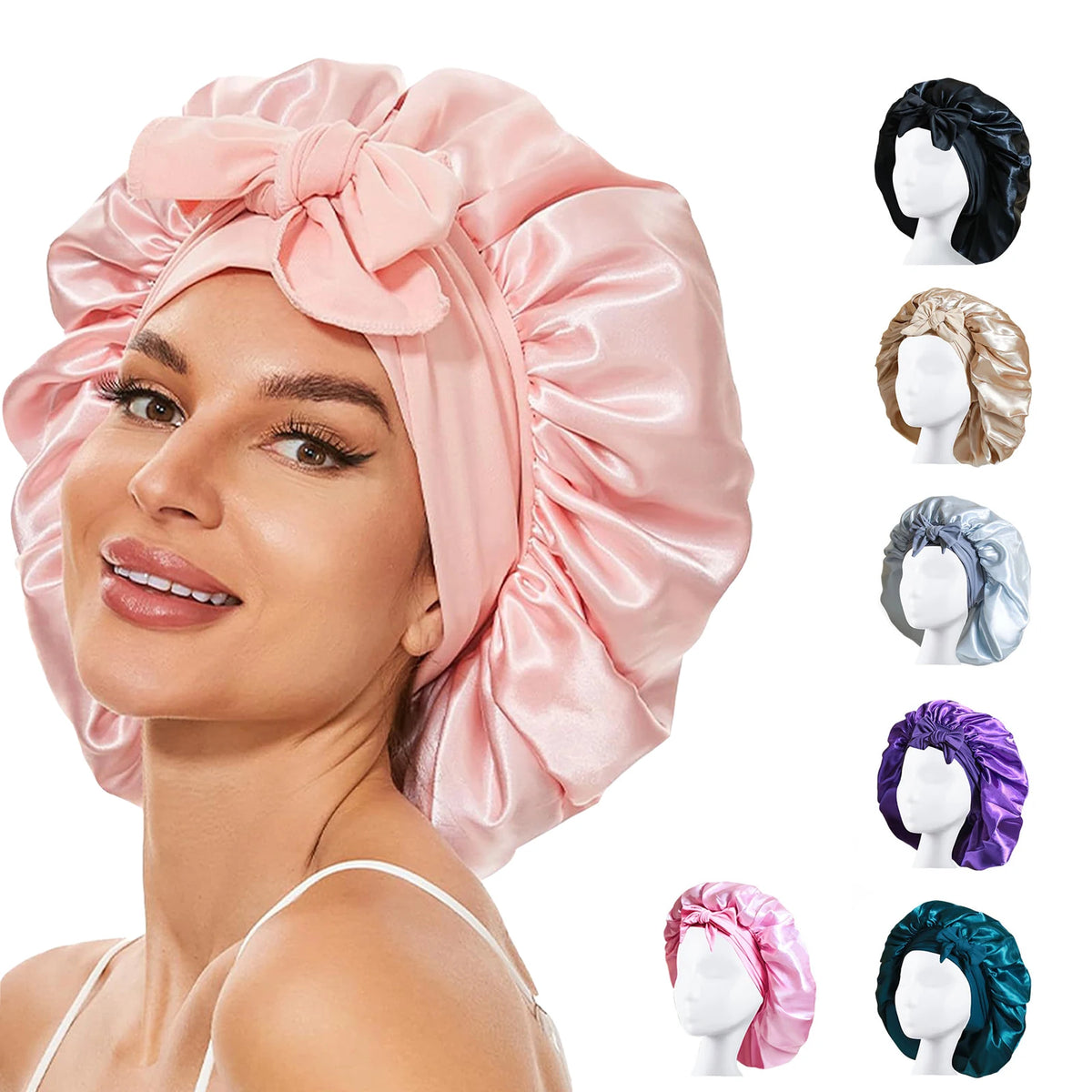 Pink silky satin sleep bonnet with a large bow and various hair accessories shown on a model's head