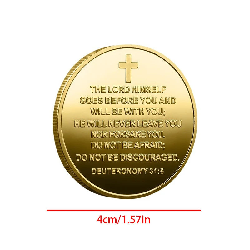 A round gold coin featuring a cross and the scripture Deuteronomy 31:8 engraved on it.