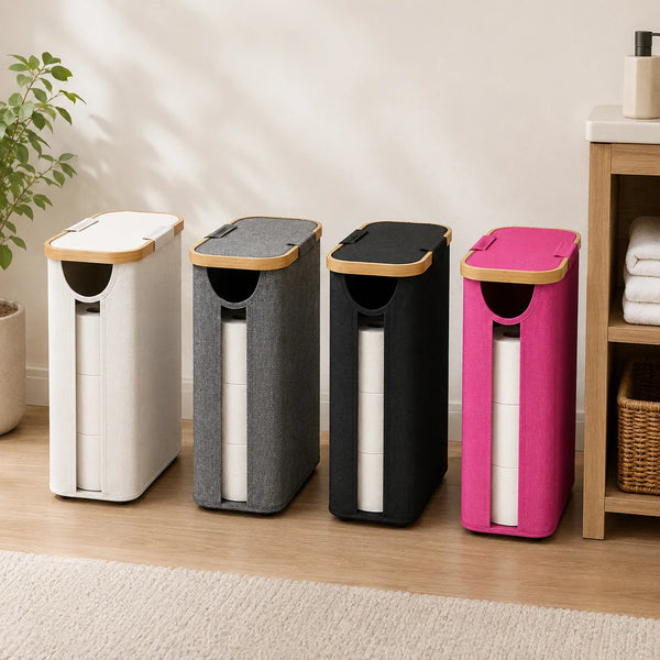 Four foldable storage baskets with lids in white, gray, black, and pink standing on a wooden floor.