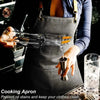 A person wearing a dark gray cooking apron is pouring oil from a bottle into a small metal cup.