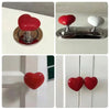 A heart-shaped toilet presser button in red and white, shown in various forms.