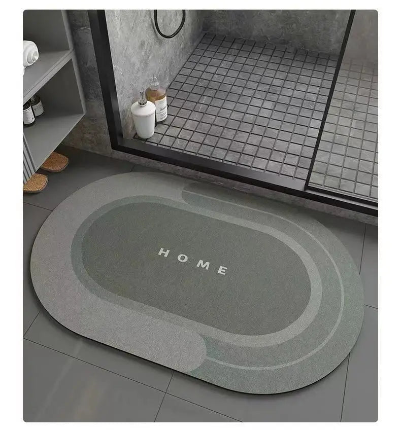 A gray anti-slip floor mat with the word HOME embossed on it, placed in front of a dark glass cabinet.