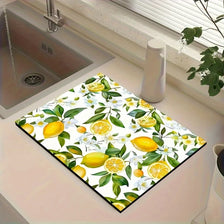 Un tapis de drainage carré avec un motif vibrant de citrons jaunes et de feuilles vertes sur fond blanc.