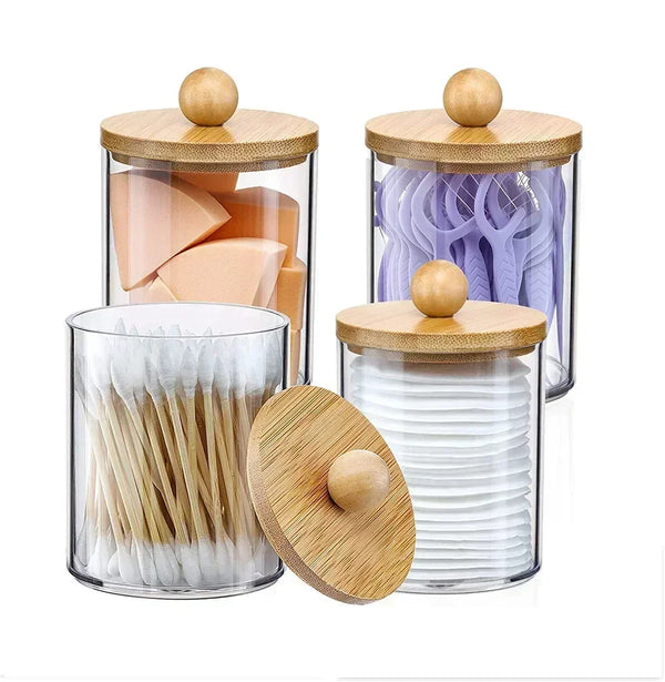 A set of glass apothecary jars with wooden lids and bamboo toothpicks for storage organization