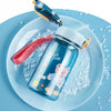 A clear glass bottle with a lid and straw is placed on a light blue plate, featuring a teddy bear design.
