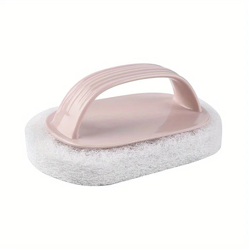 A pink magic sponge scrubber with an ergonomic handle resting on a white, porous foam pad.