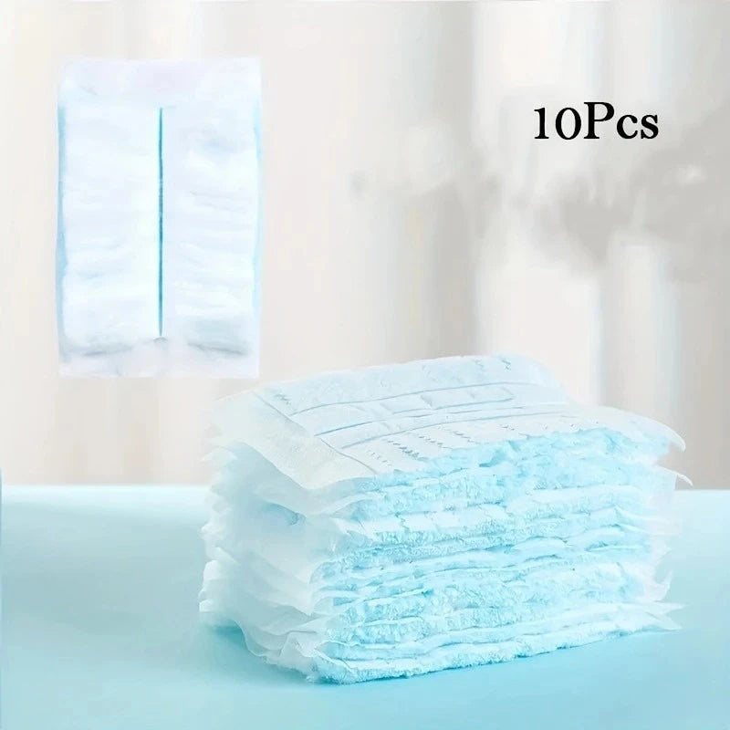 A stack of light blue disposable microfiber duster refills is shown on a surface.