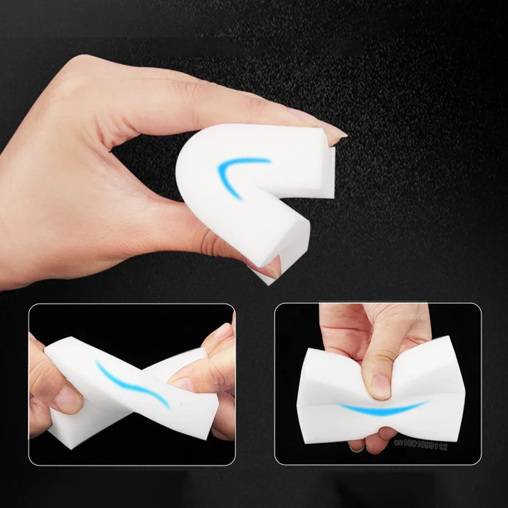 A hand holds a white melamine foam cleaning sponge shaped like a letter L, demonstrating its flexible form.