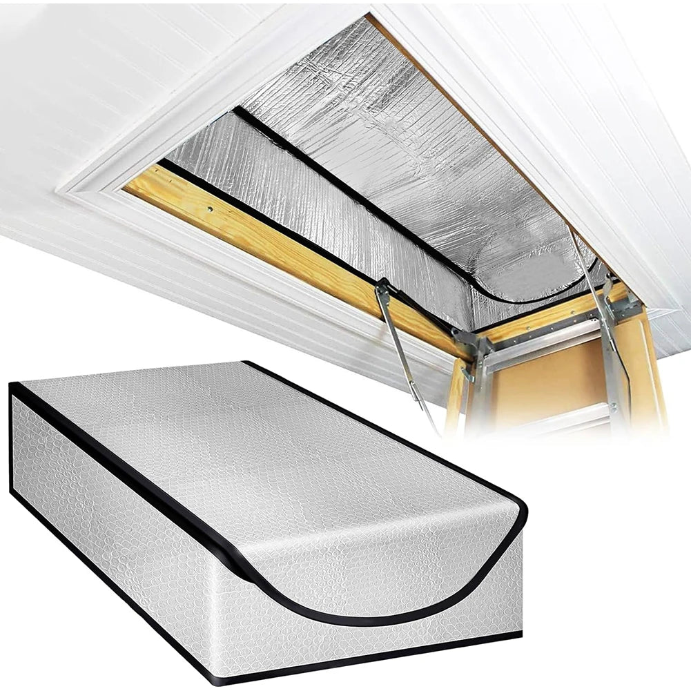 A silver attic heat and dust barrier panel installed under a white roof overhang.