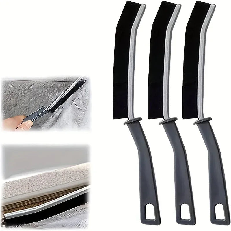 Three black crevice cleaning brushes with silver tips shown next to various surfaces.