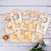 A set of wooden baby closet dividers with age labels ranging from newborn to 24 months.