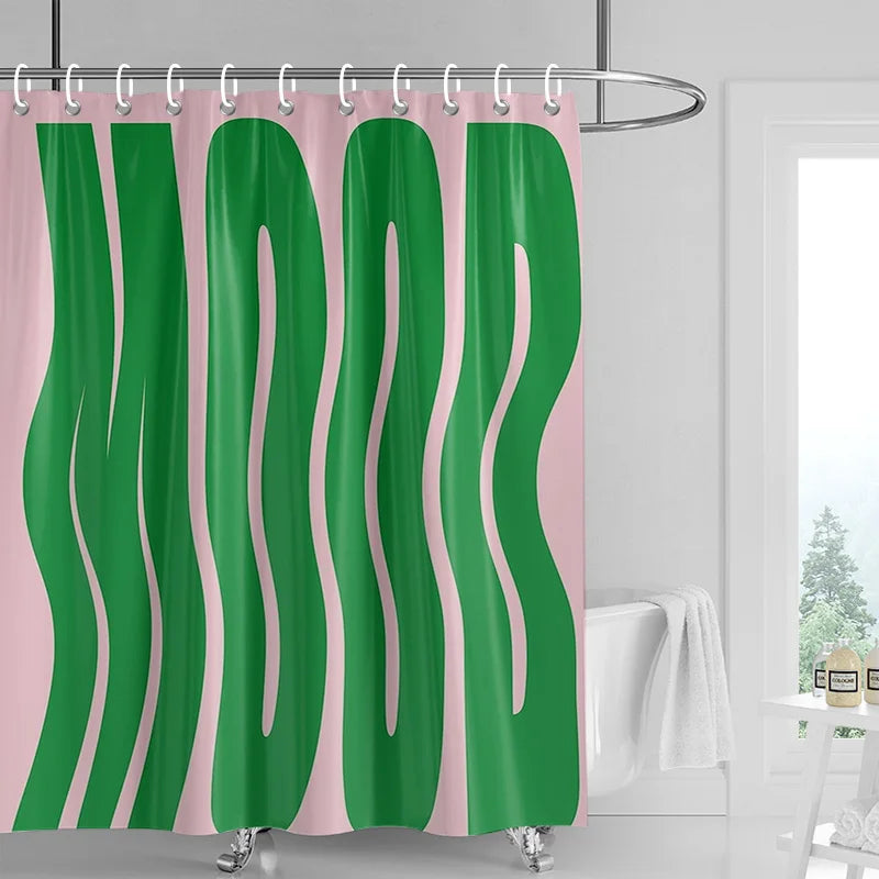 A green and pink abstract geometric art shower curtain hanging on a rod.