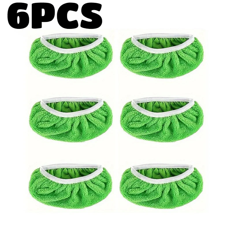 Six pieces of green reusable mop replacement cloths with white trim.