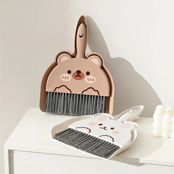 A set of pink cartoon animal broom and dustpan with a bear design
