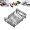 Stainless steel extendable sink drain basket with multiple slots for draining vegetables and other items.