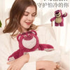 A woman is holding a pink cartoon plush toy, which is designed to be used as a hot water bottle.