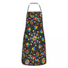 Buntes Blumen-Kunstküchenapron mit schwarzem Hintergrund, leuchtenden Blumen und Blättern.