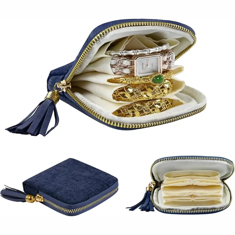 Elegant velvet jewelry storage bag with a gold-toned zipper and tassel, displaying various pieces of jewelry.