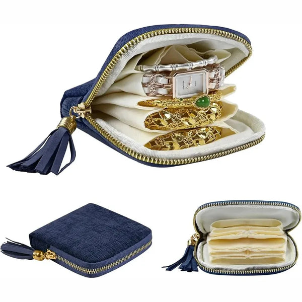 Elegant velvet jewelry storage bag with a gold-toned zipper and tassel, displaying various pieces of jewelry.