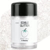 A glass jar of edible glitter powder labeled Silver Gray from Colaele with a black cap.
