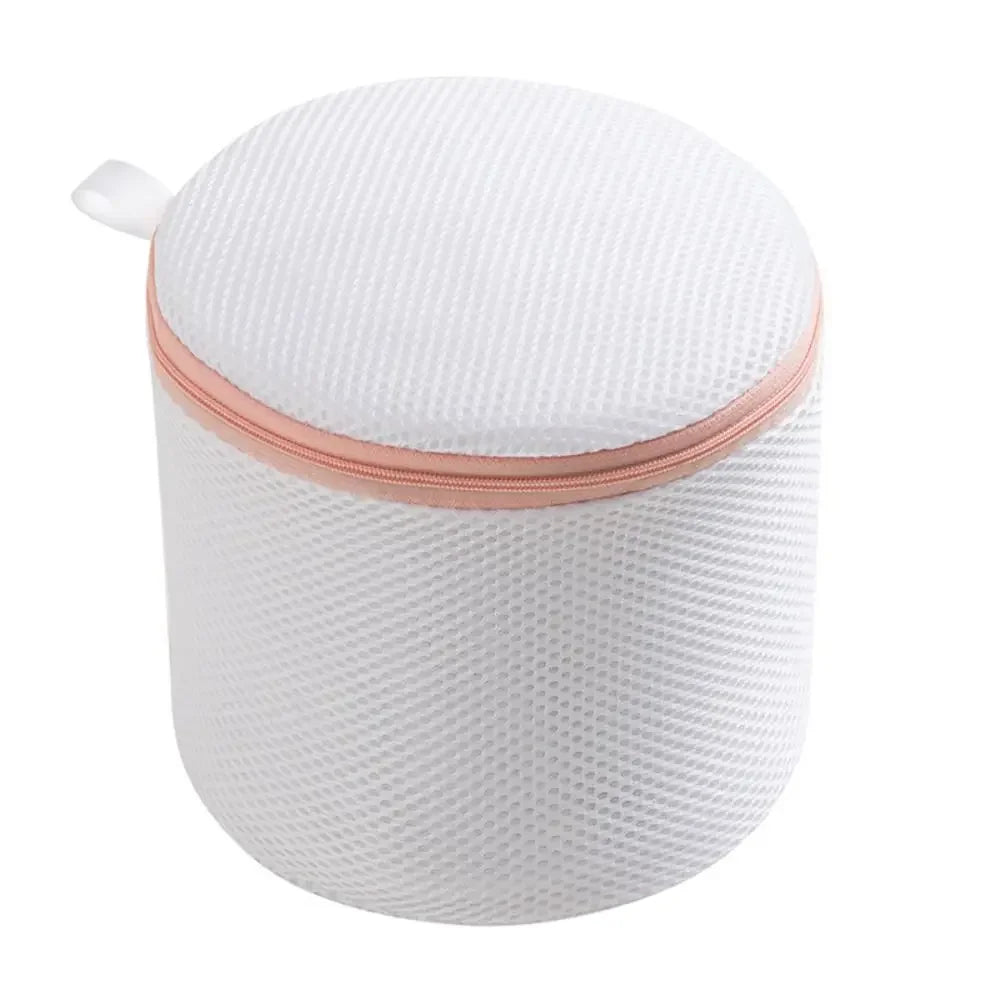 A white reusable zippered laundry bag with a pink trim, shown from the top.