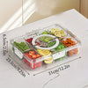 A clear plastic snack organizer tray with eight compartments filled with various fresh fruits and vegetables on a white surfa
